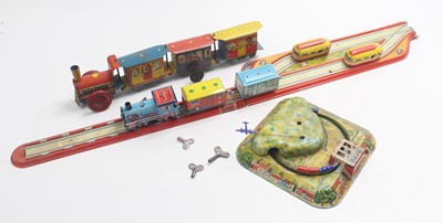 Lot 1957 - A collection of train-related tinplate toys...