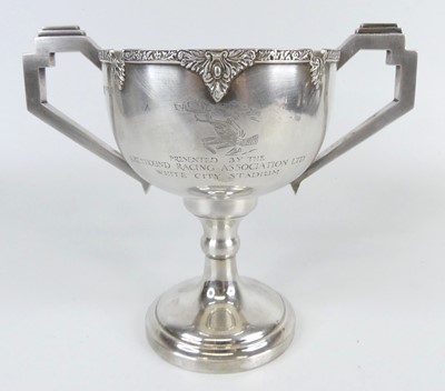 Lot 100 - An Art Deco silver twin handled pedestal...