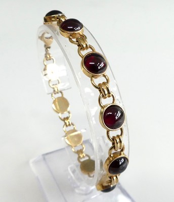 Lot 2599 - A 9ct gold cabochon garnet set bracelet,...