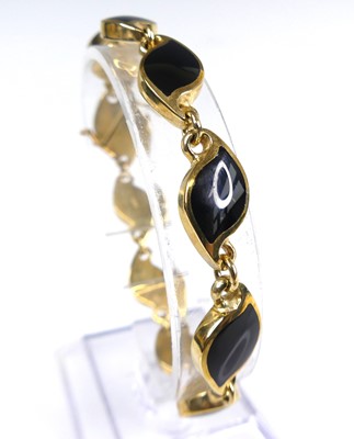 Lot 2617 - A contemporary 9ct gold and polished black...