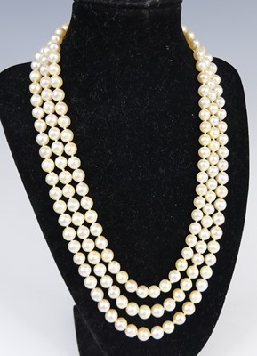 Lot 2609 - A cultured pearl triple string choker, the...