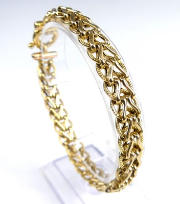 Lot 2611 - A 9ct gold spiga link bracelet, with ring...