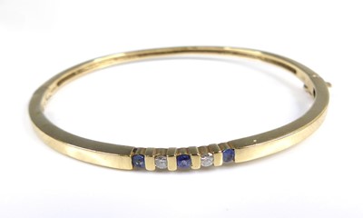 Lot 2651 - A 9ct gold sapphire and diamond set hinge...