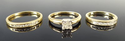 Lot 2703 - A modern 9ct gold diamond dress ring, arranged...