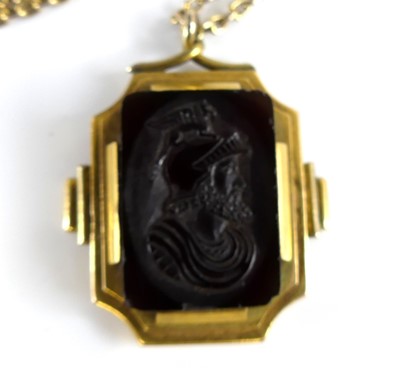 Lot 2735 - A carved carnelian pendant as a profile...