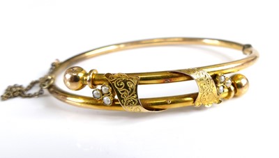 Lot 2736 - A Victorian yellow metal hollow hinge bangle,...