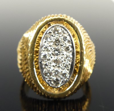 Lot 2713 - A yellow metal diamond set heavy textured oval...