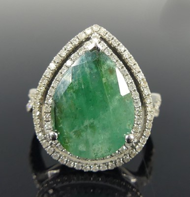Lot 2716 - A white metal emerald and diamond pear-shaped...