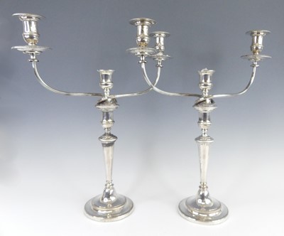 Lot 1087 - A pair of George III three-light twin branch...