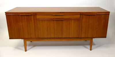 Lot 372 - A 1960s teak sideboard, having a central baize-...