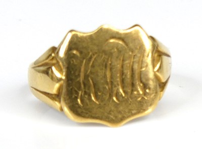 Lot 1167 - An 18ct yellow gold shield shaped signet ring,...