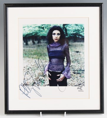 Lot 699 - P.J. Harvey, a 3/4 length colour photograph,...