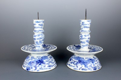 Lot 54 - A pair of Chinese blue and white candle stands,...