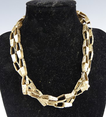 Lot 1169 - A modern 9ct gold abstract link...