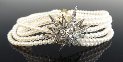 Lot 1190 - A six-row cultured pearl bracelet, featuring...