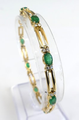 Lot 1194 - A yellow metal emerald and diamond bracelet,...