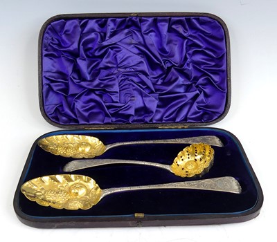 Lot 1099 - A pair of George III silver berry spoons, in...
