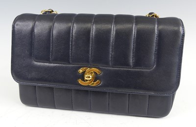 Lot 134 - Coco Chanel - a navy leather 'Madamoiselle'...