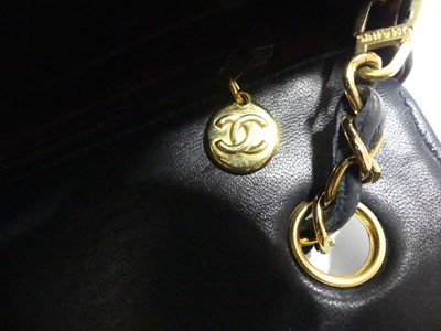 Lot 134 - Coco Chanel - a navy leather 'Madamoiselle'...