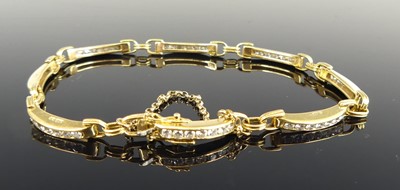 Lot 1191 - An 18ct yellow gold diamond bar bracelet,...