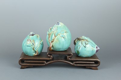 Lot 2109 - Three Chinese porcelain moulded peaches on a...