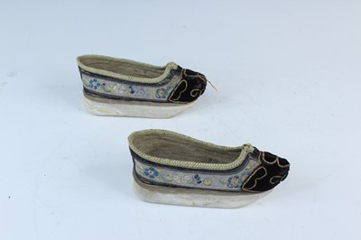 Lot 2196 - A pair of Chinese embroidered shoes, 1900s....