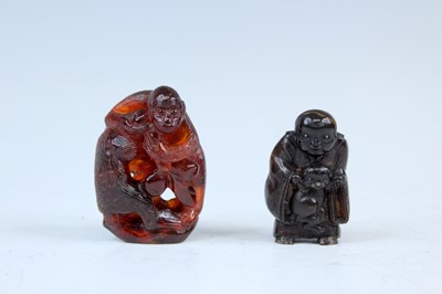 Lot 2235 - A Japanese amber netsuke of two monkeys, Meiji...