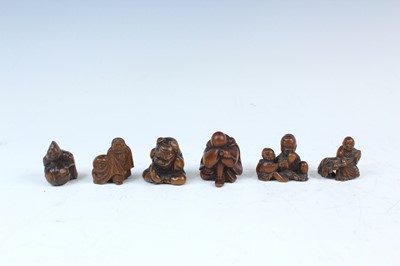 Lot 2233 - Six Japanese wood netsuke of seated figures,...