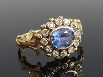 Lot 2508 - A yellow metal sapphire and diamond oval...