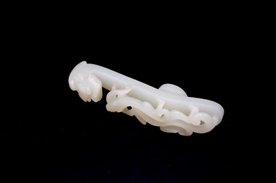 Lot 2046 - A Chinese white jade ‘dragon’ belt hook, 18th...