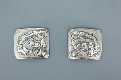 Lot 2062 - A pair of Chinese silver ‘dragon’ buckles,...