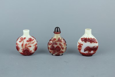 Lot 2019 - A set of three Chinese red overlay white glass...