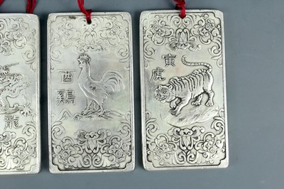 Lot 2058 - Seven Chinese white metal zodiac plaques...