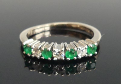 Lot 2513 - An 18ct white gold, emerald and diamond half...