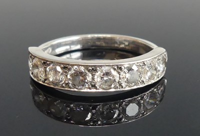 Lot 2113 - A white metal diamond half eternity ring,...