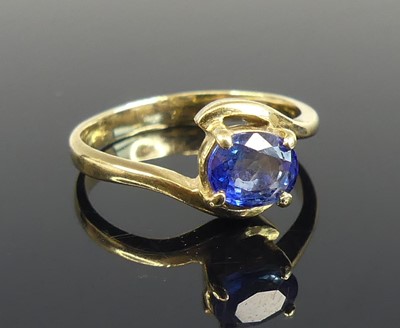 Lot 2575 - A yellow metal sapphire crossover style ring,...