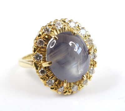 Lot 2580 - A yellow metal, sapphire and diamond oval...