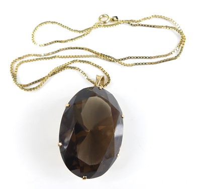Lot 2581 - A yellow metal oval faceted smoky quartz...