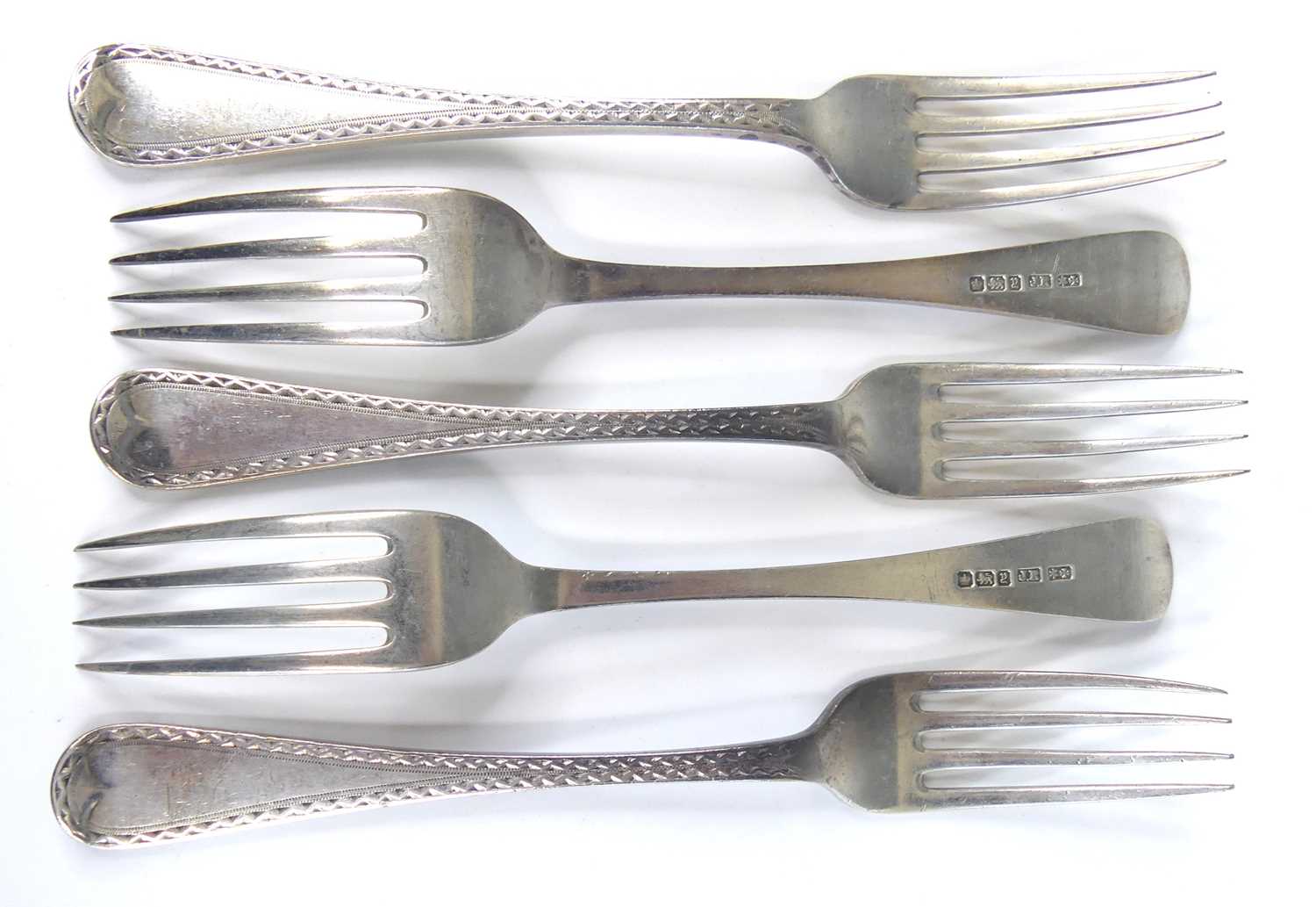 Lot 2057 - A set of five silver forks, in the Old English...