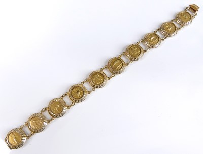 Lot 2542 - An Egyptian Revival yellow metal disc bracelet,...