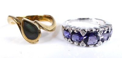 Lot 2552 - A 9ct white gold tanzanite and diamond half...