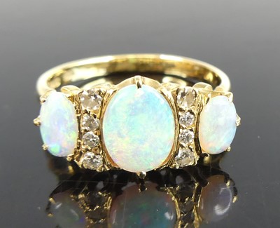 Lot 2555 - An 18ct yellow gold opal and damond dress ring...