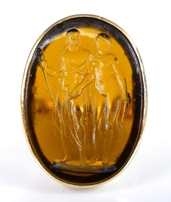 Lot 2556 - A yellow metal glass intaglio dress ring, the...