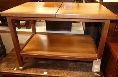 Lot 1210 - A 1970s teak two-tier tea trolley, on roller...