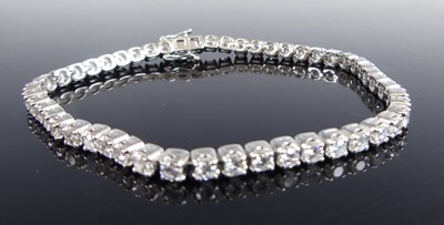 Lot 2716 - A platinum diamond tennis bracelet, comprising...