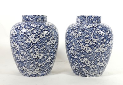 Lot 11 - A pair of transfer decorated pottery jars and...
