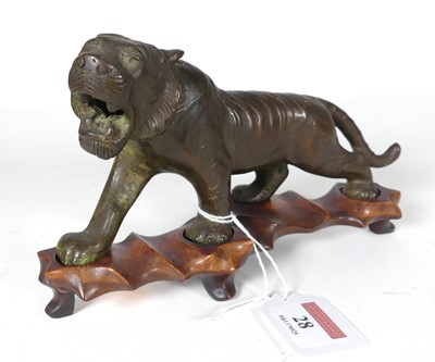 Lot 28 - A Japanese bronze figure of a tiger, modelled...