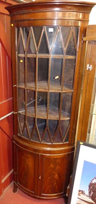 Lot 1121 - A mahogany bowfront corner cupboard, having...