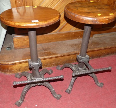 Lot 1125 - A pair of cast iron based and stained pine...