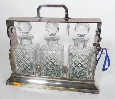 Lot 141 - An Edwardian silver plated three decanter...